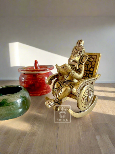 Ganesha sitting on rocking chair & reading book - The Golden Heritage #